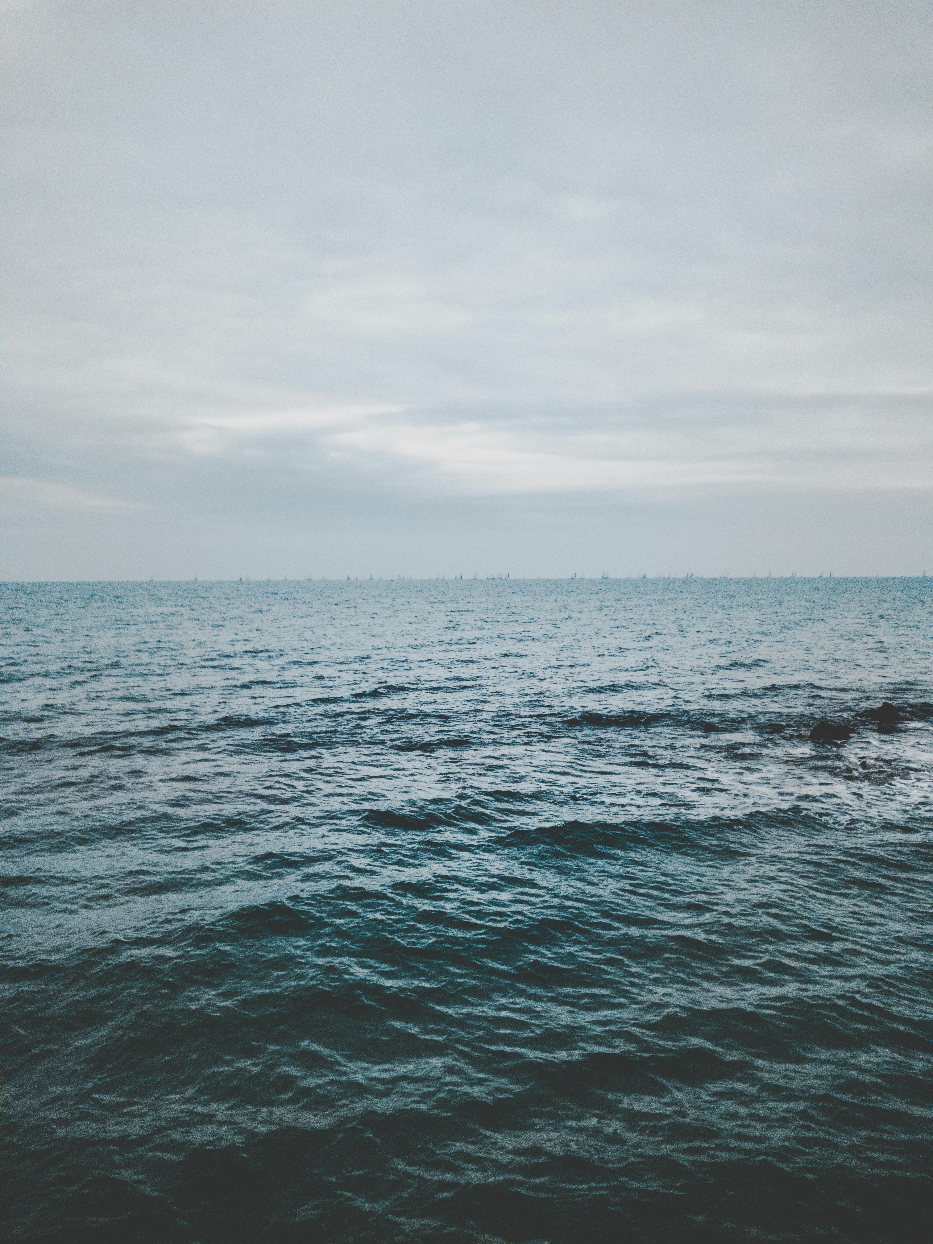 Ocean Under Cloudy Sky Free Stock Photo