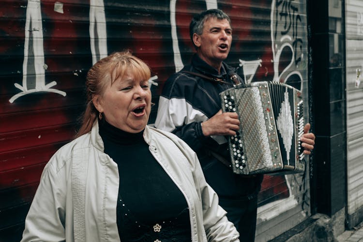 Man And Woman Singing On The Street