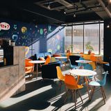 Bright cafe with painted mural wall — photo by Mikhail Morozov on Pexels