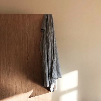 Merch shirt hanging on a studio wall — photo by Mikhail Morozov on Pexels
