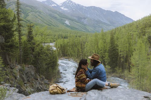 Man and Woman Sitting on a Rocky Cliff