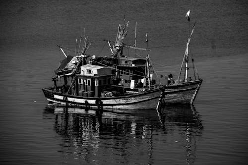 Grayscale Photo of Boats on the Sea