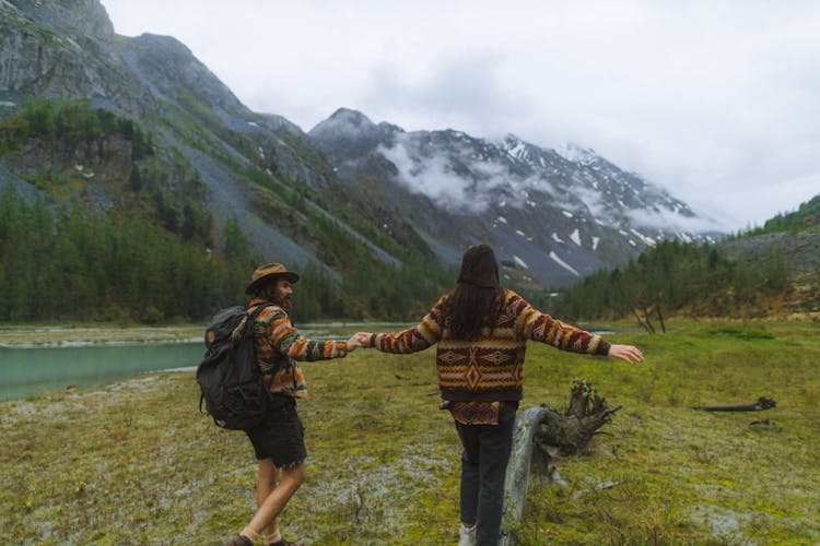 A Couple Walking On Grass Field