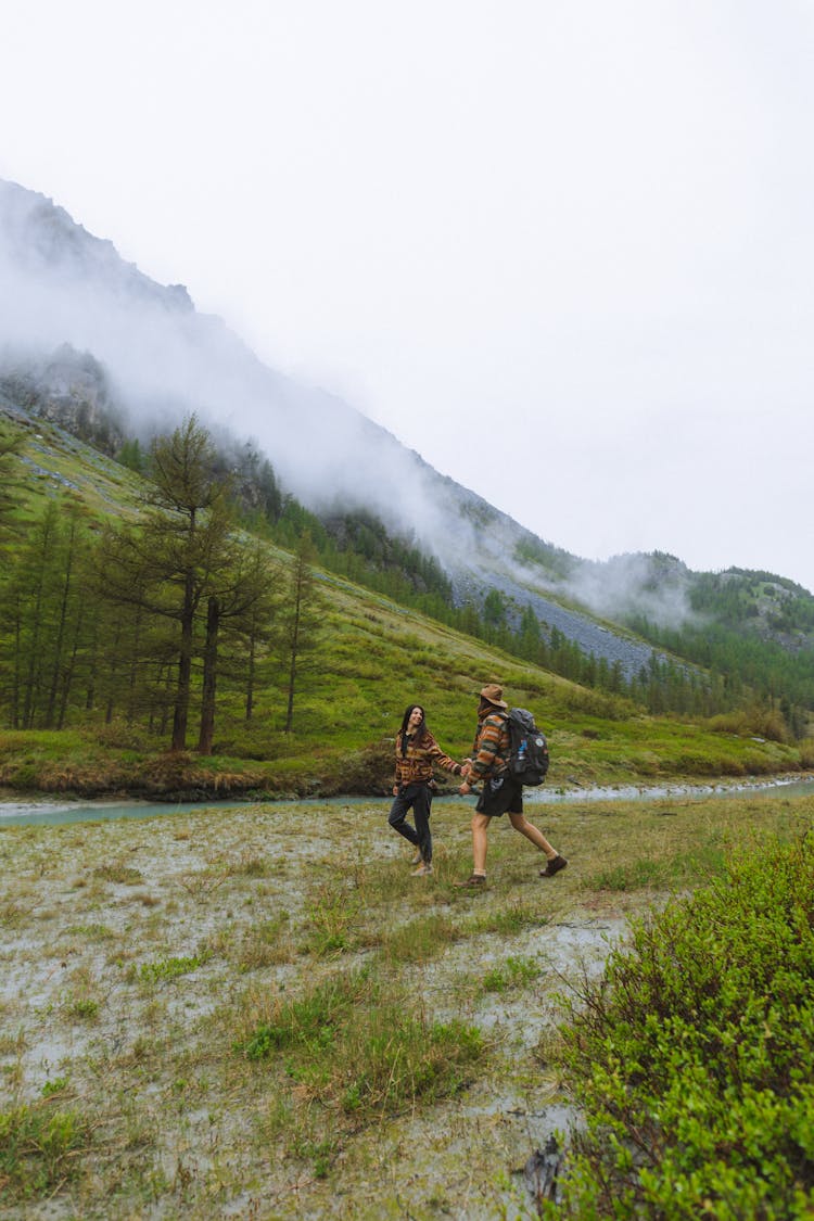 A Couple Walking Beside The River