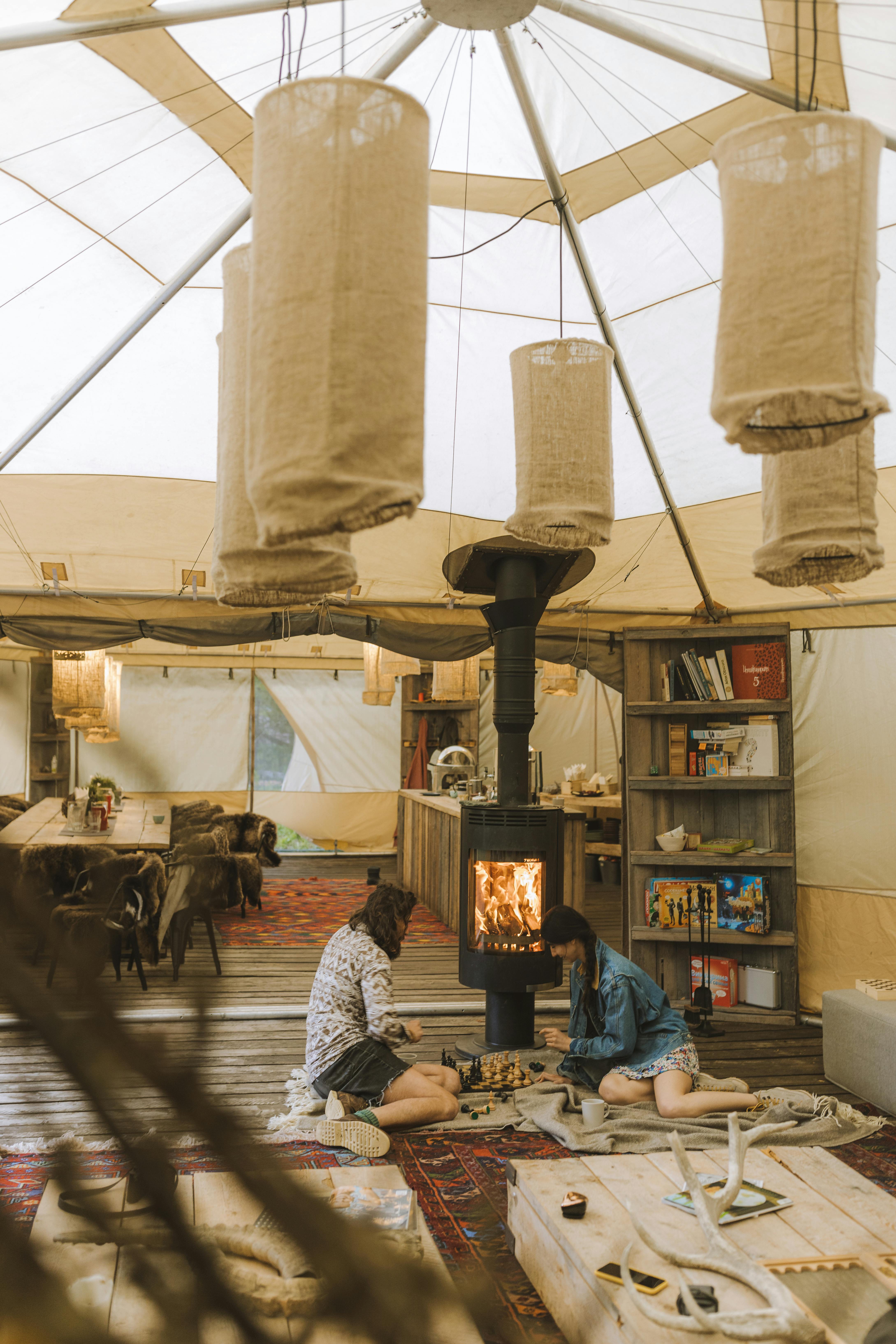 people sitting on carpeted floor near fireplace