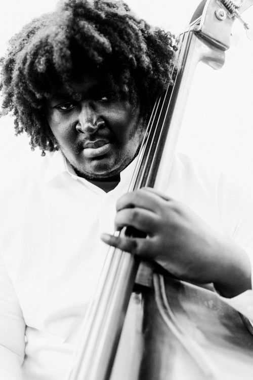 Free Expressive black and white portrait of a musician playing a double bass with intensity. Stock Photo