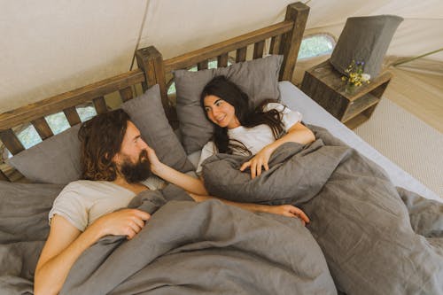 Free A Couple Lying on the Bed Stock Photo