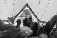 Grayscale Photo of Woman in Tent