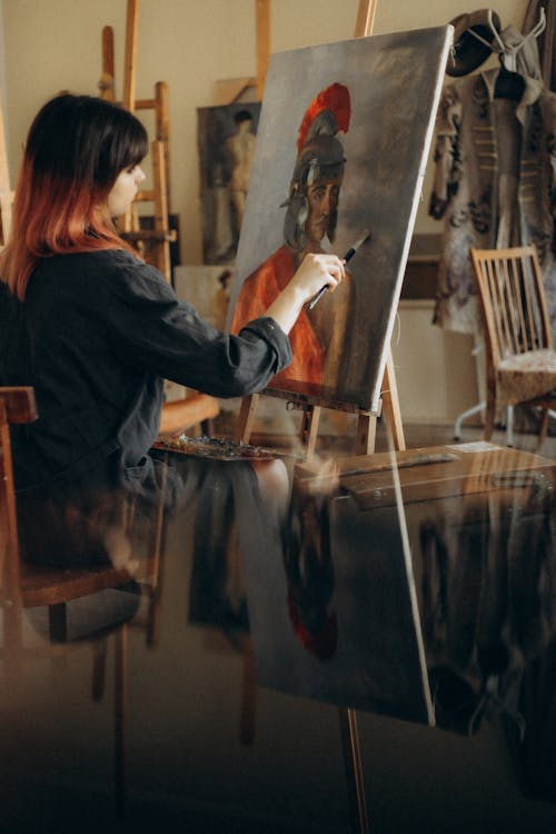 Free A Woman in Black Long Sleeves Painting Using a Paintbrush Stock Photo