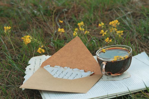 A Brown Envelope Near the Cup of Coffee