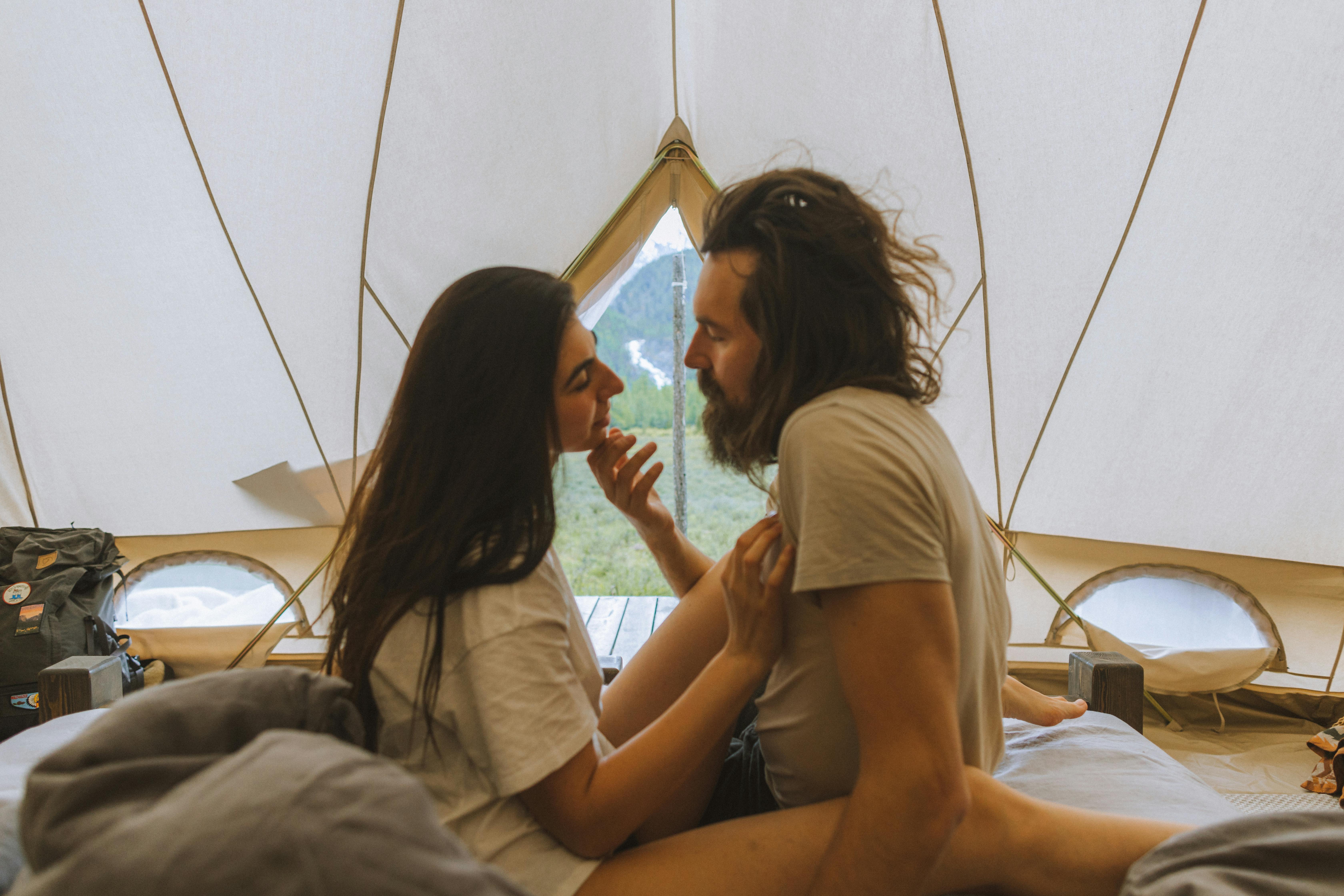 couple sitting inside the white tent