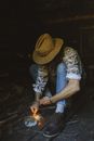 Man Starting a Fire with Hay