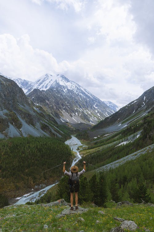 Back View of a Person Looking at the Beautiful Scenery of Mountains