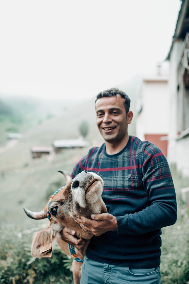 Smiling Man Hugging Cow