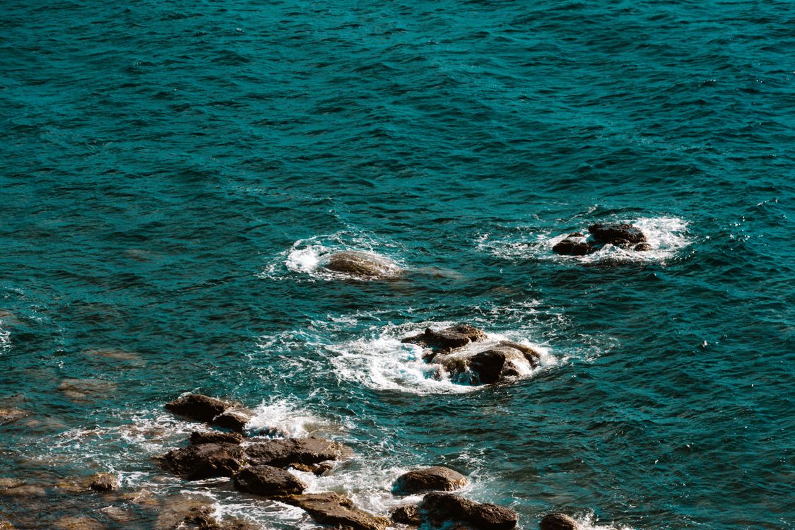 Rocks in Green Sea Water · Free Stock Photo