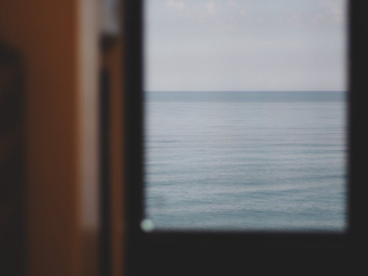 View Of Calm Ocean Surface Through Boat Window