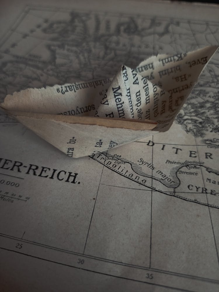 Paper Ship On An Old Map