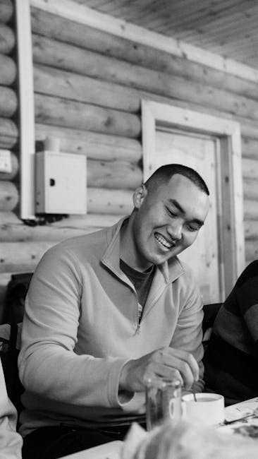 Monochrome portrait of a smiling man indoors in Kazakhstan.