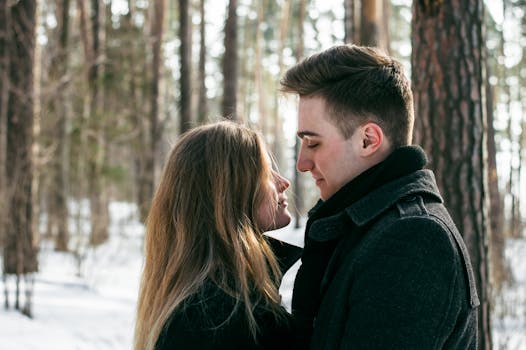 Man Wearing Black Coat Facing Woman Wearing Black Coat Near Tree