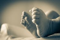 Baby's Feet in Gray Scale Photography