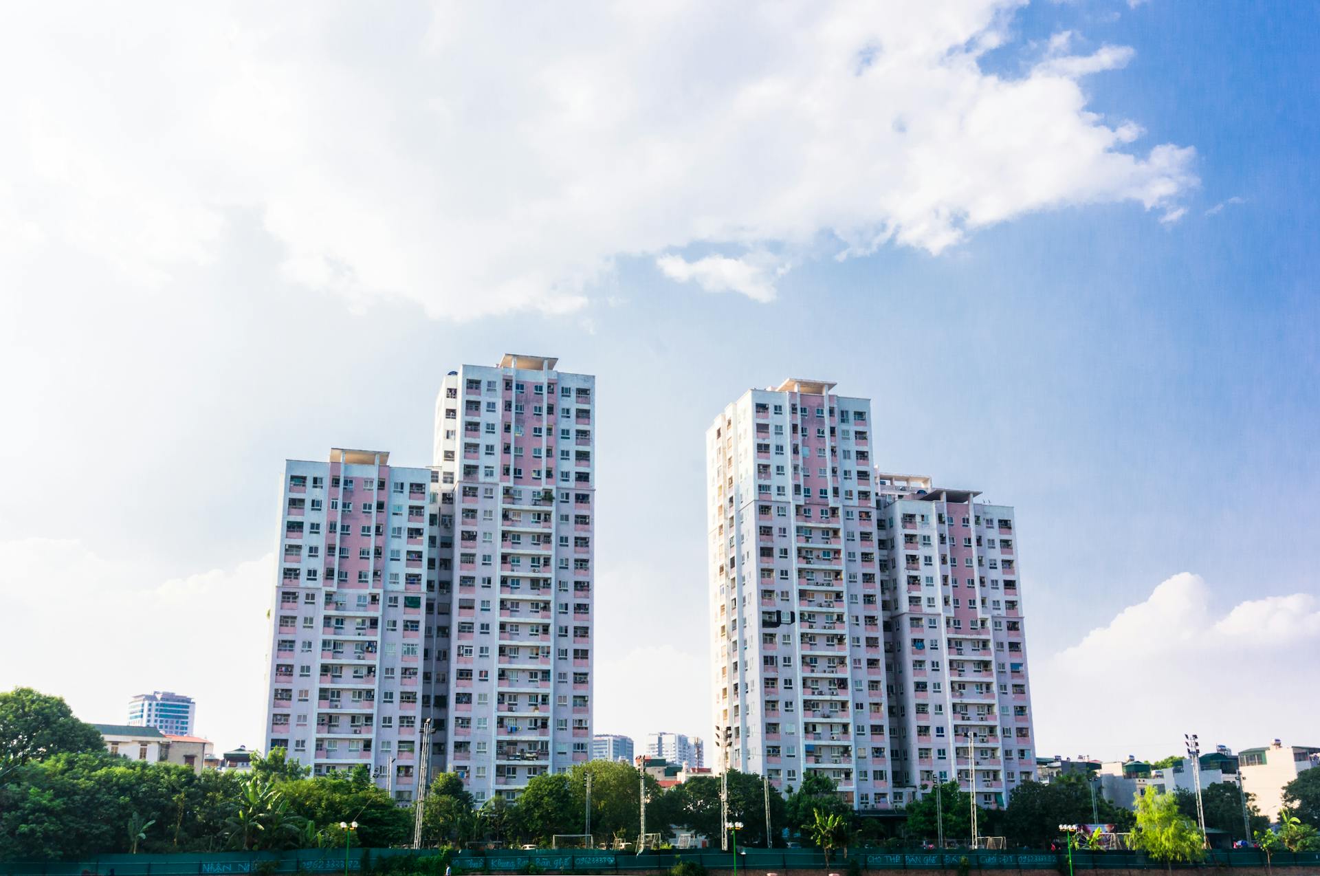 Explore modern high-rise architecture with a view of residential towers under a blue sky, offering an urban living perspective.