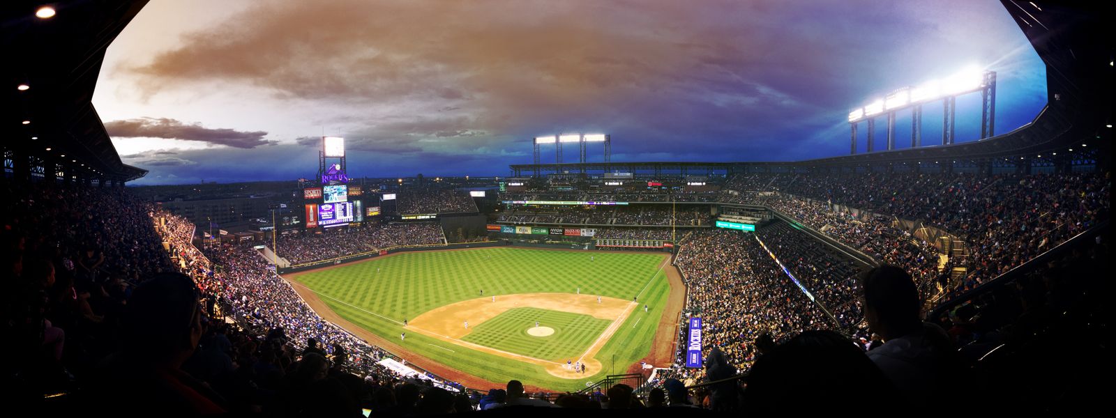 Packed baseball stadium under the lights