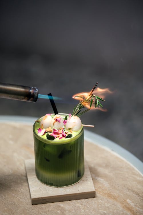 Decorated Matcha Latte on a Wooden Tray with a Flame