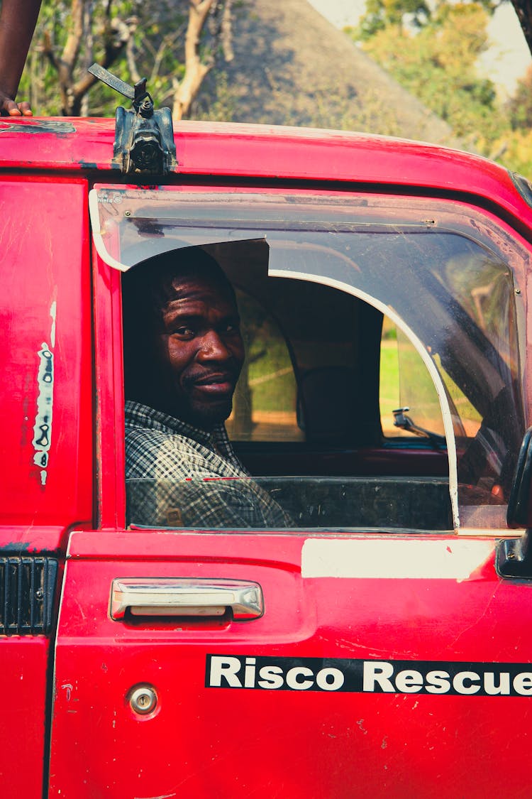 Man In Cabin Of Red Rescue Truck