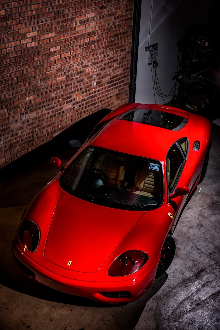 A Red Sports Car Parked Inside The Garage