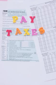 Colorful letters on tax forms, ideal for finance and tax-related themes.