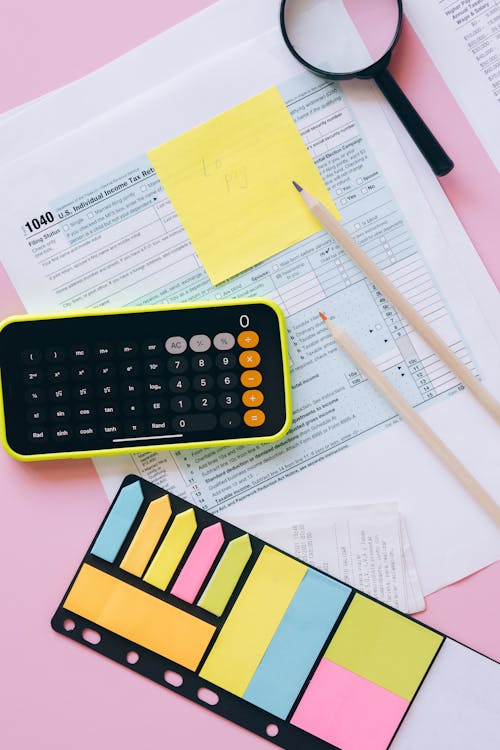 Calculator and Sticky Notes on Papers