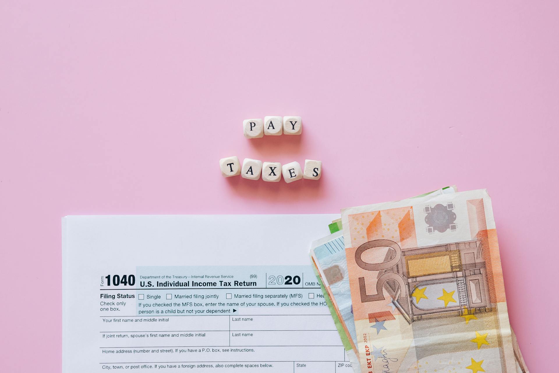 Money on the White Form Beside the Letter Blocks