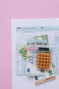 A vibrant flat lay of a calculator, euro banknotes, and US tax forms on a pink background.