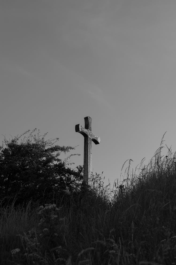 Grayscale Photo Of A Cross On A Hill