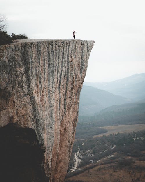 Person Standing on Cliff