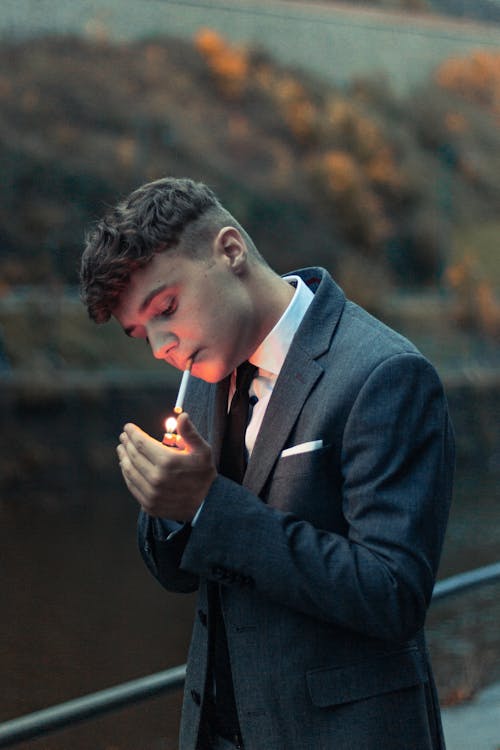 Free A Man Lighting a Cigarette  Stock Photo