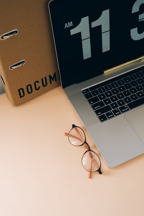 Free A Laptop and Eyeglasses on the Table Stock Photo