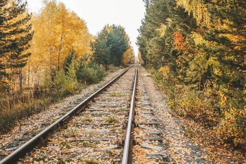 Free Beautiful autumn railway surrounded by colorful trees and nature in Тюмень, Россия Stock Photo