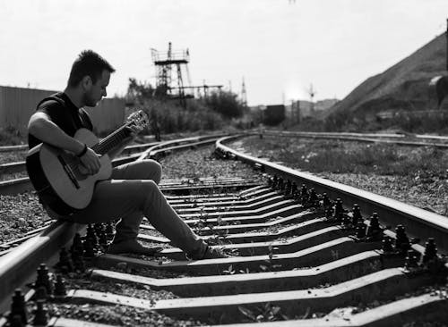 A Man Playing Guitar in the Railway