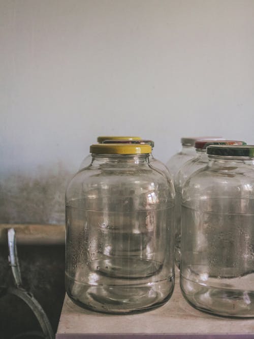 Glass Bottles With Lid On Table