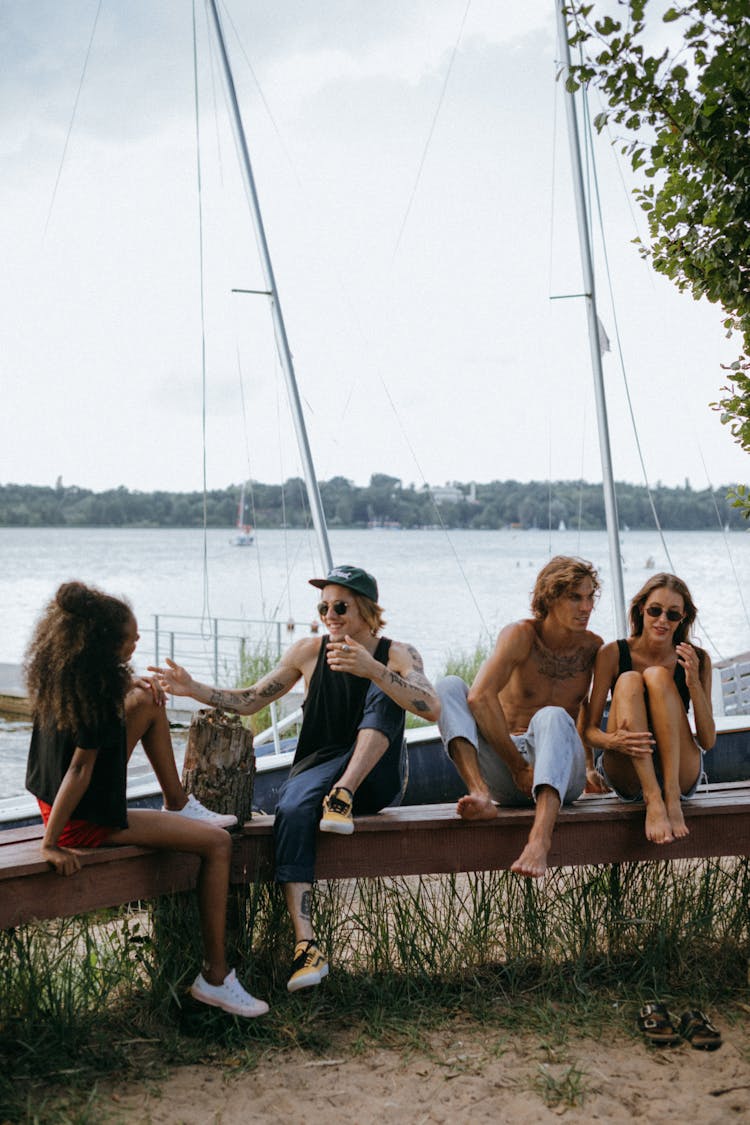 Men And Women On The Beach Sitting On A Bench