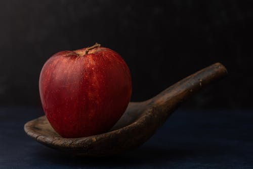 Free An Apple on a Wooden Spoon Stock Photo