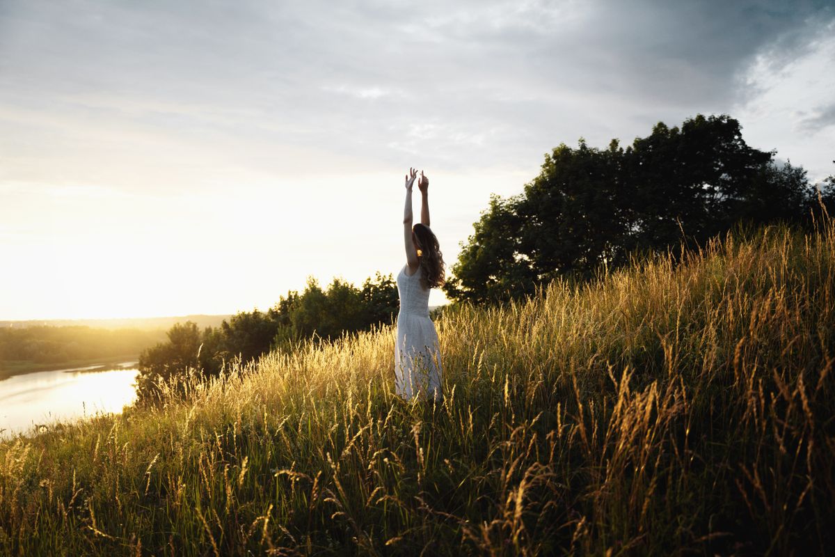 Woman in nature at sunrise