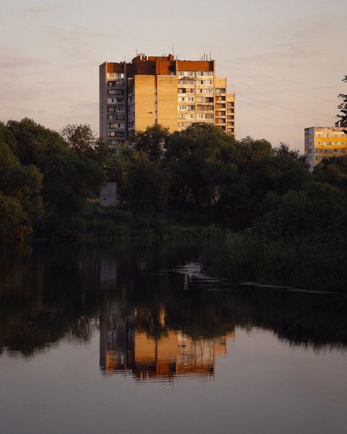 Free Discover a serene urban landscape with river reflections in St. Petersburg, Russia at sunset. Stock Photo