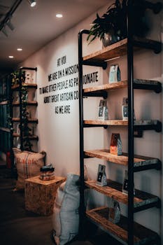 Stylish interior of a modern café with coffee bean bags and display shelves.