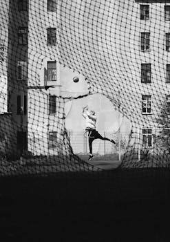Dynamic urban basketball shot through a net, highlighting street sports culture.