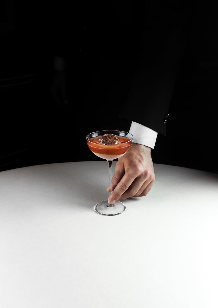 Man's Hand In Suit Holding Glass With Cocktail 