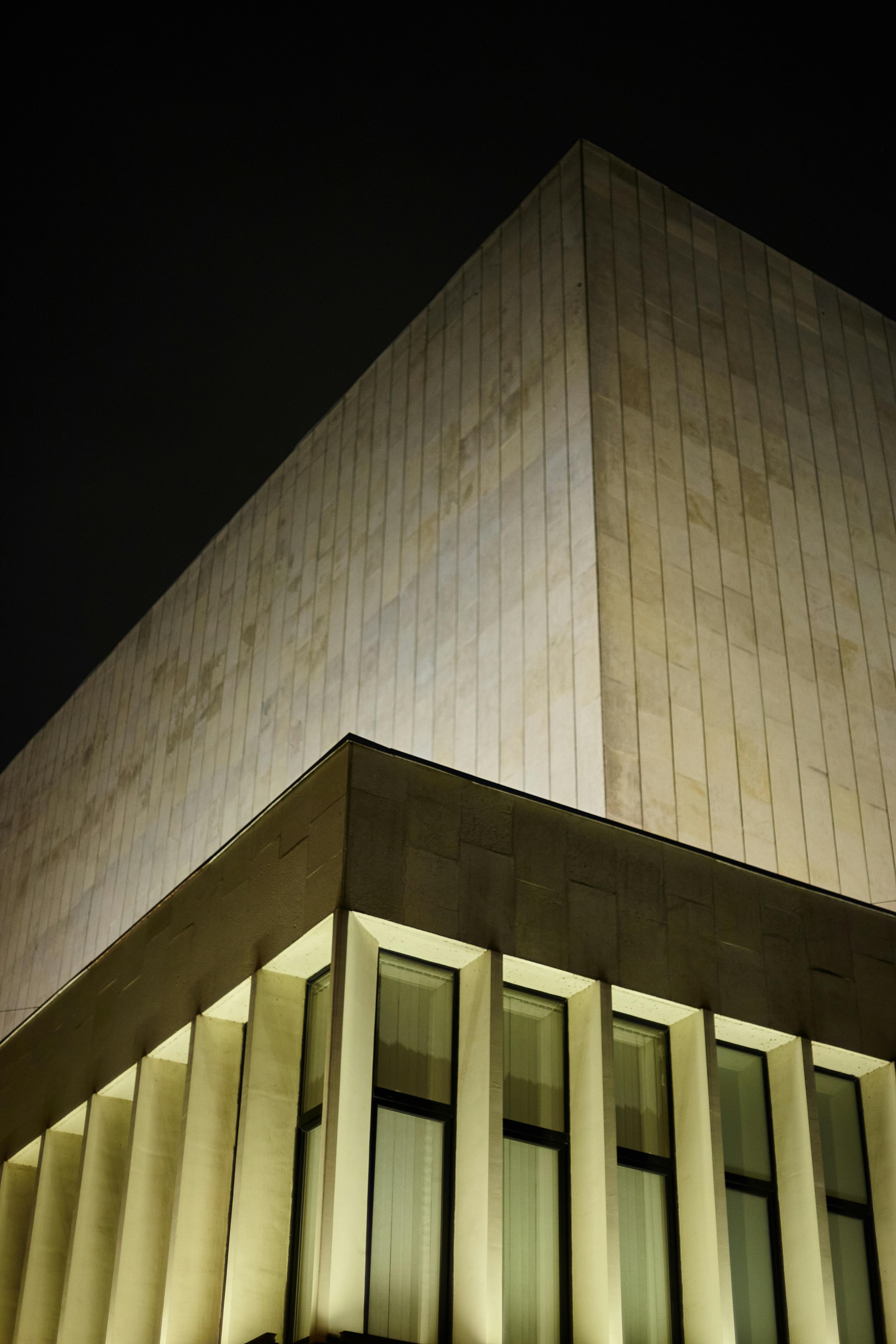 A contemporary geometric building in Saint Petersburg, Russia, illuminated against the night sky.