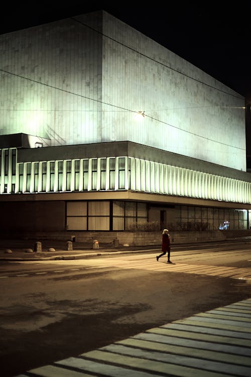 Person Crossing The Street At Nighttime