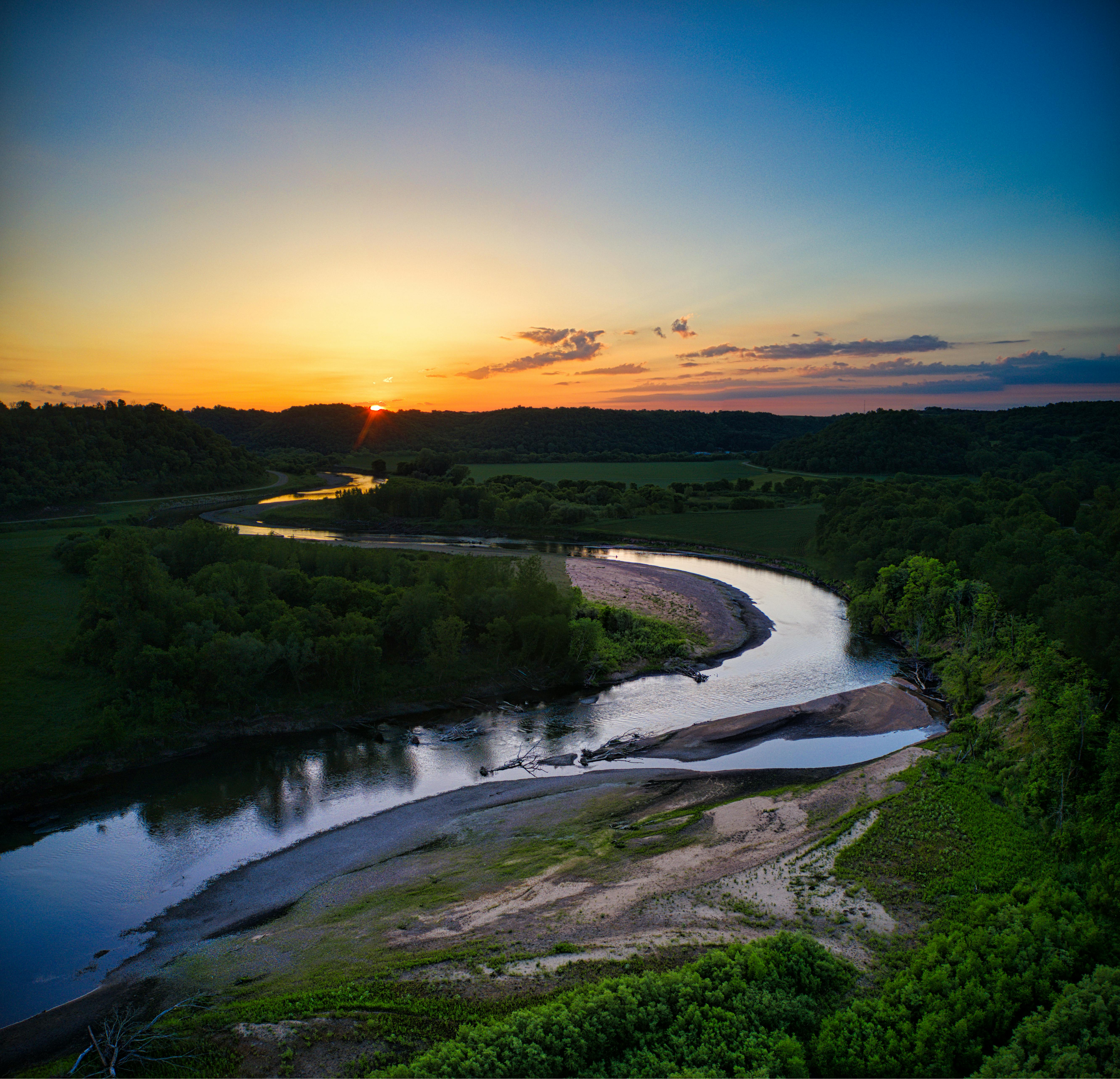 Captivating sunset over a winding river in scenic Minnesota landscape.